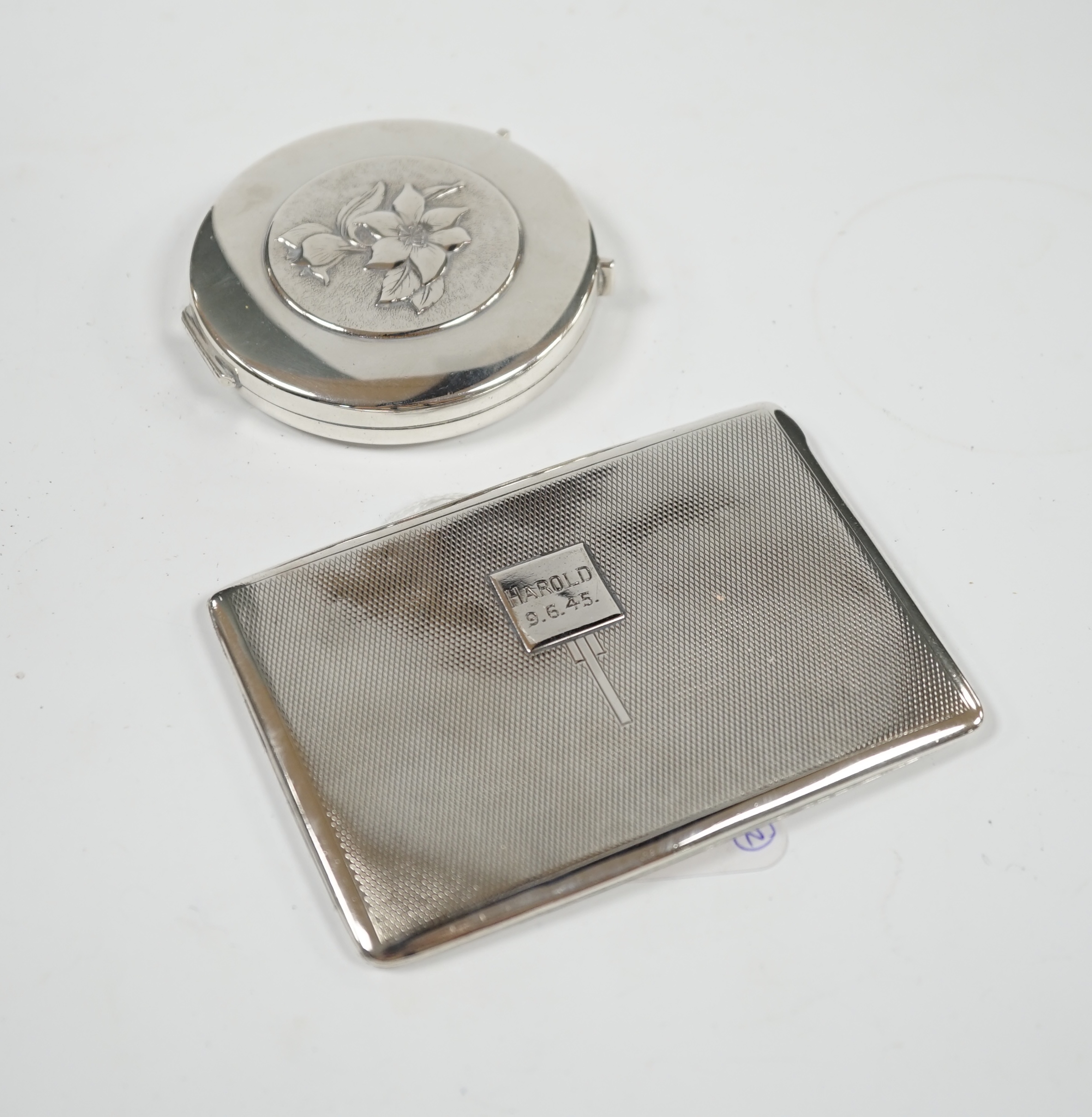 A George VI engine turned silver cigarette case, 11.5cm, together with a Spanish white metal compact. Condition - poor to fair